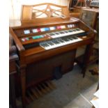 A vintage Wurlitzer Total Tone Custom twin bank electric organ in polished wood case with moulded