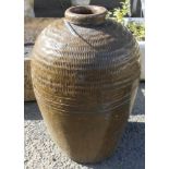 A dark olive green glazed bulbous pot with ribbed decoration and impressed numeric heart shaped