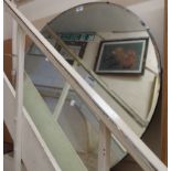 An 84cm diameter vintage frameless bevelled wall mirror