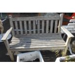 A 1.21m teak slat back garden bench, set on square legs