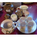 Six pieces of Poole pottery including brown unglazed vase with geometric design, egg cruet,