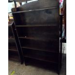 A 76cm 20th Century stained oak six shelf open bookcase, set on bracket feet