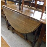 A 1.04m 1920's oak gateleg dining table, set on turned supports