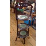 An Art Nouveau stained wood three tier cake stand, set on slender square supports - repairs