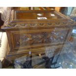 A carved wood jewellery box with birds, oak leaves and acorn panels to sides and set on acanthus
