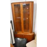 A 86cm vintage teak corner cabinet with glazed doors to top, canted sides and cupboard doors to