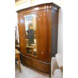A 1.49m early 20th Century mahogany and ebonised strung break bow-front wardrobe with hanging