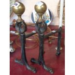 A pair of Art Nouveau iron and brass andirons
