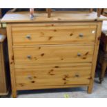 A 1.1m modern pine chest with three long drawers, set on block feet