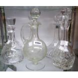 Five assorted decanters including Thomas Webb ship design, Edwardian claret jug, etc.