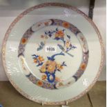 A Chinese porcelain dished plate decorated to well with bird on flowering branch - a/f