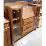 A 1.20m 20th Century oak side-by-side bureau/bookcase with central fall and three drawers flanked by