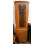 A modern teak effect two part corner cabinet with glazed top section and cupboard to base