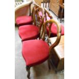 A set of four mahogany framed balloon back dining chairs with studded red velour upholstery, set
