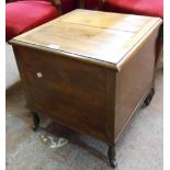 A late Victorian stained and mixed wood box commode with china liner and iron casters - splits