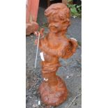A small reproduction iron figure of a cherub playing a lyre