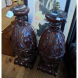 A pair of 67cm stained and carved hardwood acanthus scroll baluster shaped floor lamps