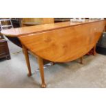 A 1.93m Irish stained alder drop-leaf wake table with single gated action, set on tapered legs