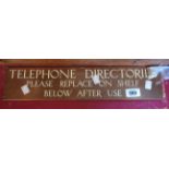 A vintage brass plaque with enamel lettering Telephone Directories