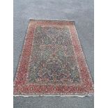 A Middle Eastern wool rug with mille florie ground and profus floral border - minor moth - size on