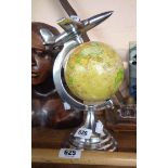 A globe with aeroplane to top