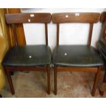 A set of six retro stained teak framed dining chairs with leatherette upholstered seats and curved
