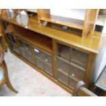 A 1.87m 20th Century stained mixed wood book cabinet with central recessed shelf and two glazed