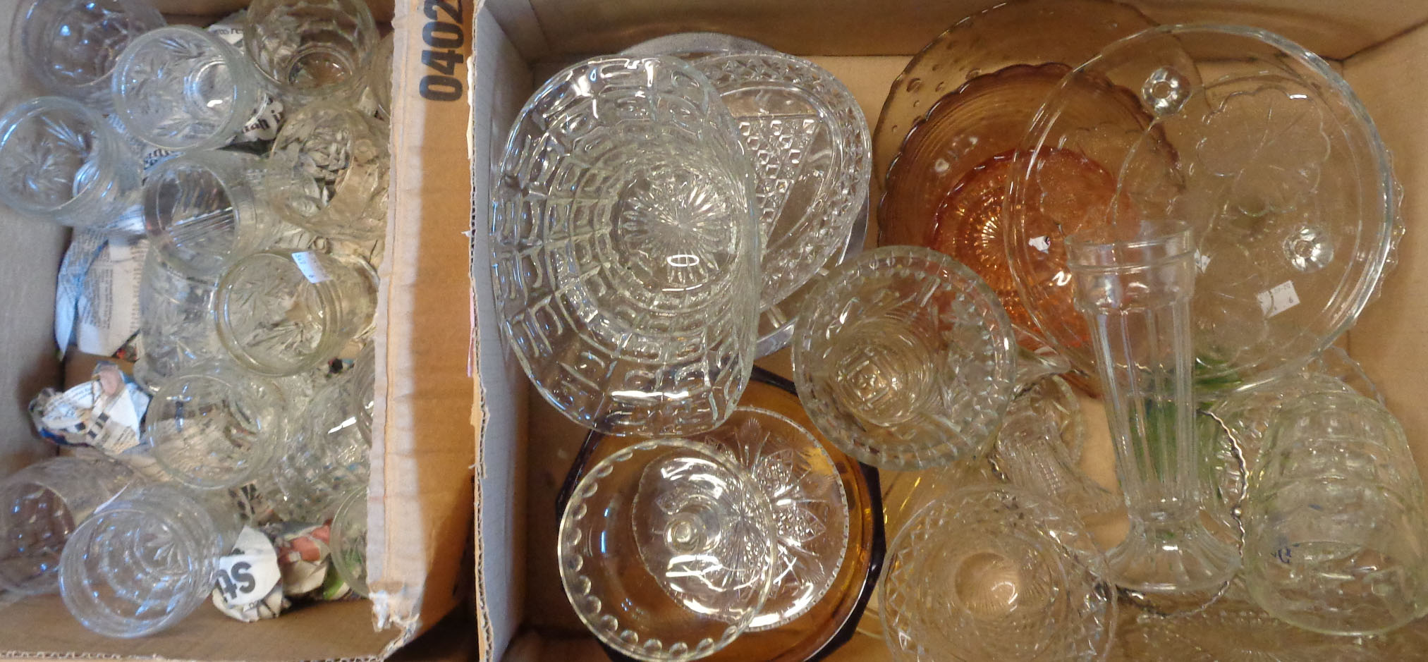 Two boxes containing assorted glassware including cut and moulded glasses, comports, etc.