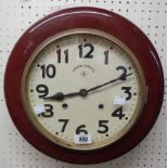 A 36cm diameter varnished wood cased dial wall clock with Arabic numerals and dial marked Ansonia