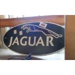 A modern reproduction painted iron Jaguar sign