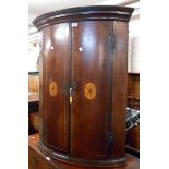 A 79cm 19th Century inlaid mahogany bow front wall hanging corner cabinet with shelves enclosed by a