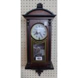 A modern stained wood cased wall timepiece with visible pendulum and dial marked Highlands with