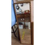 A 34cm gilt framed narrow oblong wall mirror