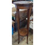 An Edwardian mahogany and strung two tier jardiniere stand, set on splayed square supports -
