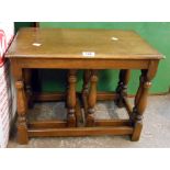 A nest of three polished oak tea tables, set on turned supports