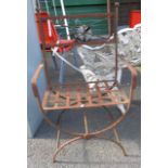 An iron framed garden elbow chair with lattice seat