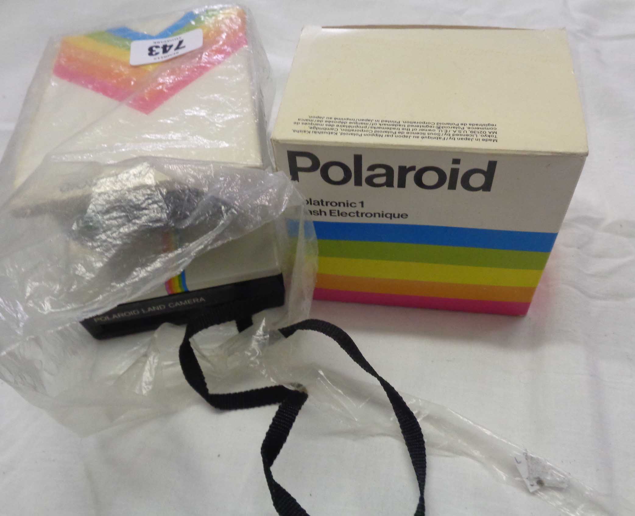 A Polaroid 1000 land camera with instructions and boxed Polartronic flash