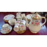 A Royal Crown Derby Royal Pinxton Roses coffee set comprising eight trios, coffee pot, cream and