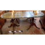 A 1.18m 20th Century reproduction mahogany and leather inset twin pedestal coffee table with glass