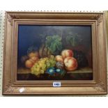 Ame Perret: a gilt framed oil on panel still life with fruit and flowers on a marble surface in