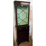 A 56cm reproduction mahogany book cabinet with glazed top, two short drawers and panelled cupboard