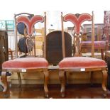 A pair of late Victorian stained wood framed ornate high back chairs with low upholstered seats