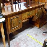 A 1.22m Edwardian mahogany and strung knee-hole dressing table with central drawer and flanking