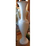 A large white ceramic floor vase with gilt highlighting