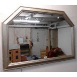 A 97cm silvered gilt framed wall mirror with canted top