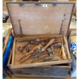 A vintage painted pine carpenter's tool chest containing planes, chisels, brace drill, etc.