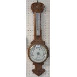 A late Victorian carved oak cased banjo barometer/thermometer with dial marked for Perrett & Joyner,