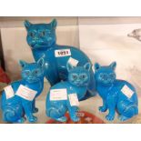 A large Chinese turquoise glazed cat figurine - sold with three smaller similar