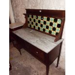 A 1.07m Edwardian washstand with tile set splashback, damaged marble top and pair of panelled