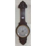 An early 20th Century carved oak framed aneroid barometer - no thermometer scale - dial glass a/f